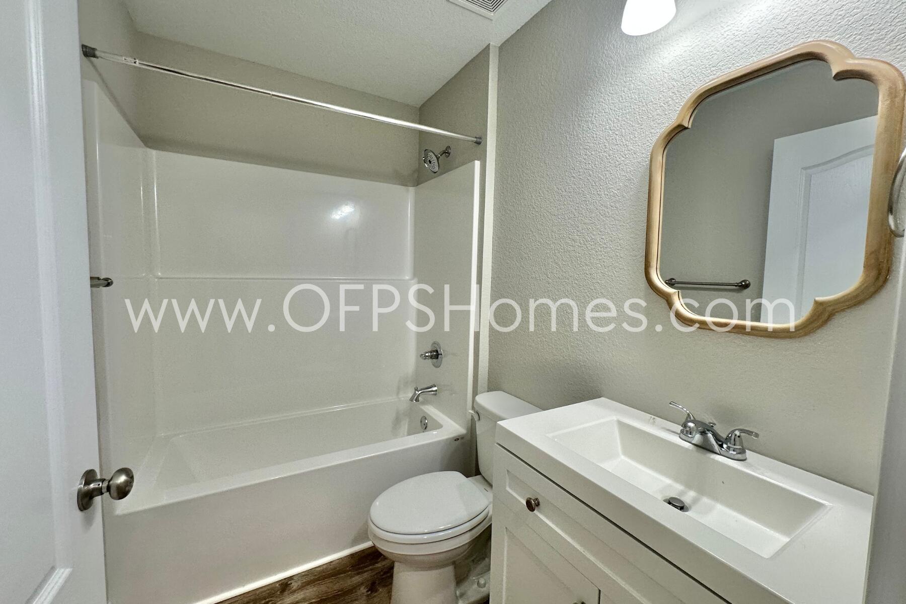 6762 Trailride North Milton, FL 32570 - Photo 17 of 25 a bathroom with a sink toilet and shower