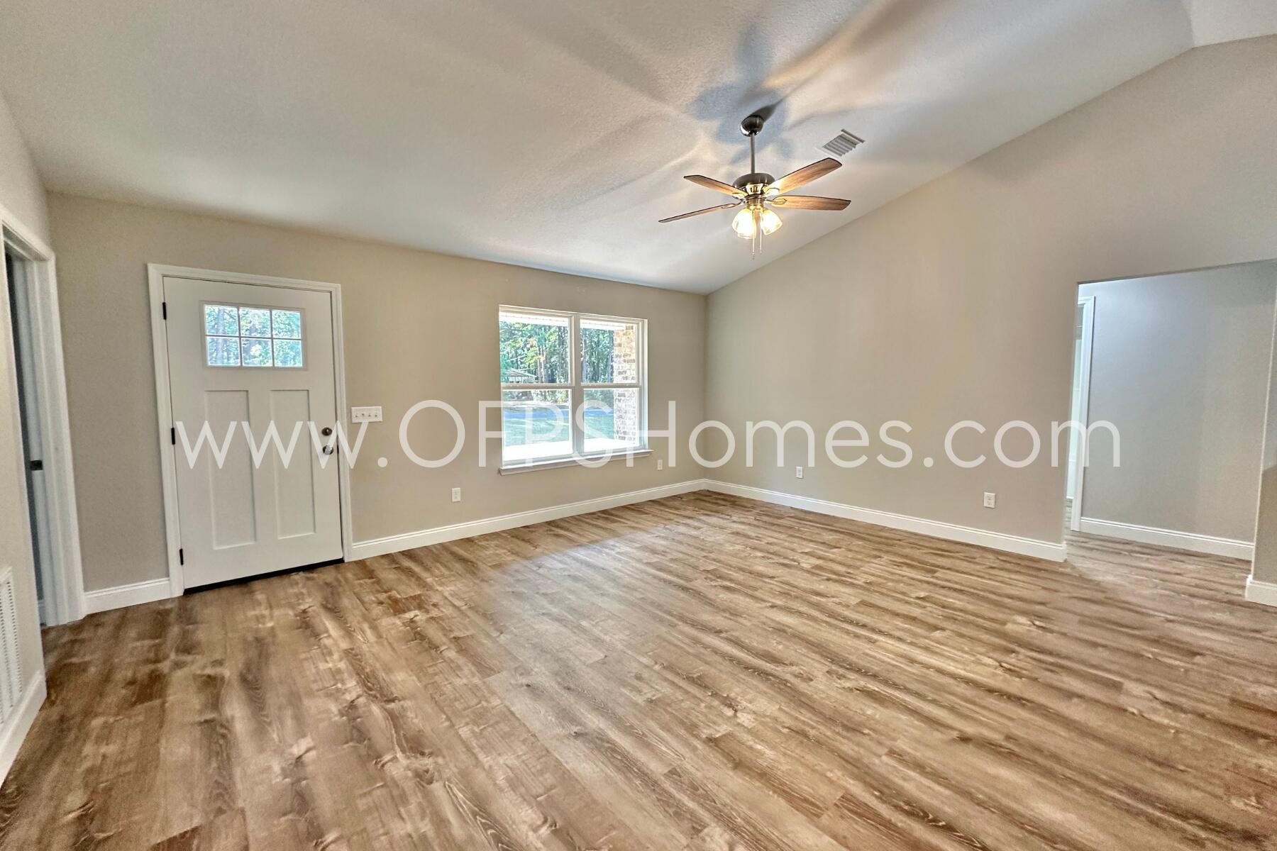 6762 Trailride North Milton, FL 32570 - Photo 5 of 25 a view of an empty room with a window and wooden floor