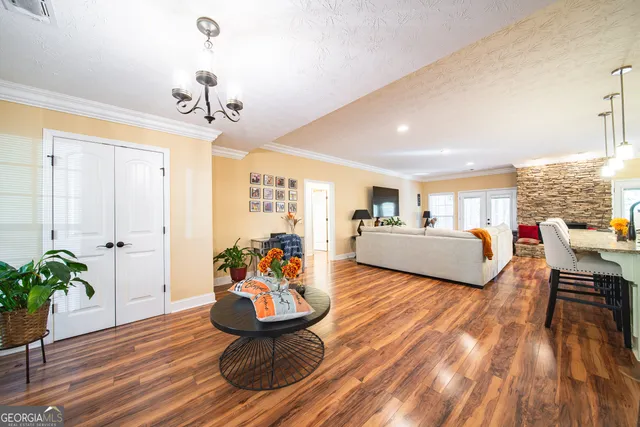 a living room with furniture and wooden floor