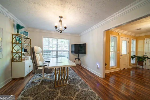 a view of a livingroom with furniture wooden floor and windows