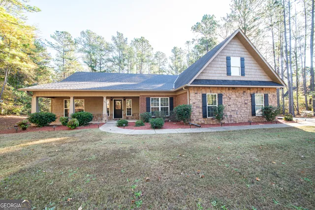 a front view of a house with yard patio and green space