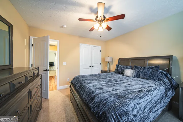 a bedroom with a large bed and a chandelier