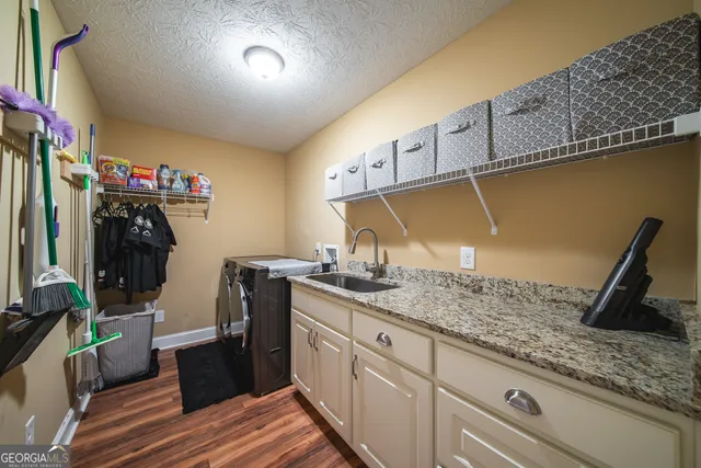 a kitchen with sink and refrigerator
