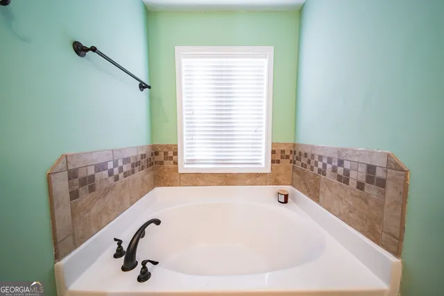 a bathroom with a tub and a window