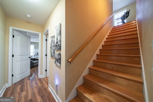 a view of entryway and gallery with wooden floor