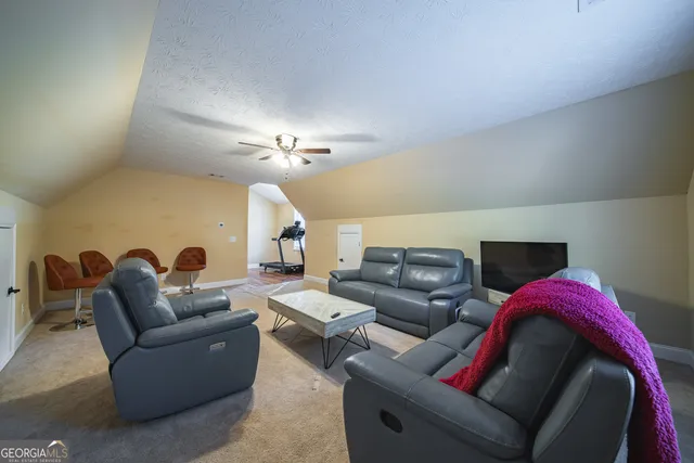 a living room with furniture and a mirror