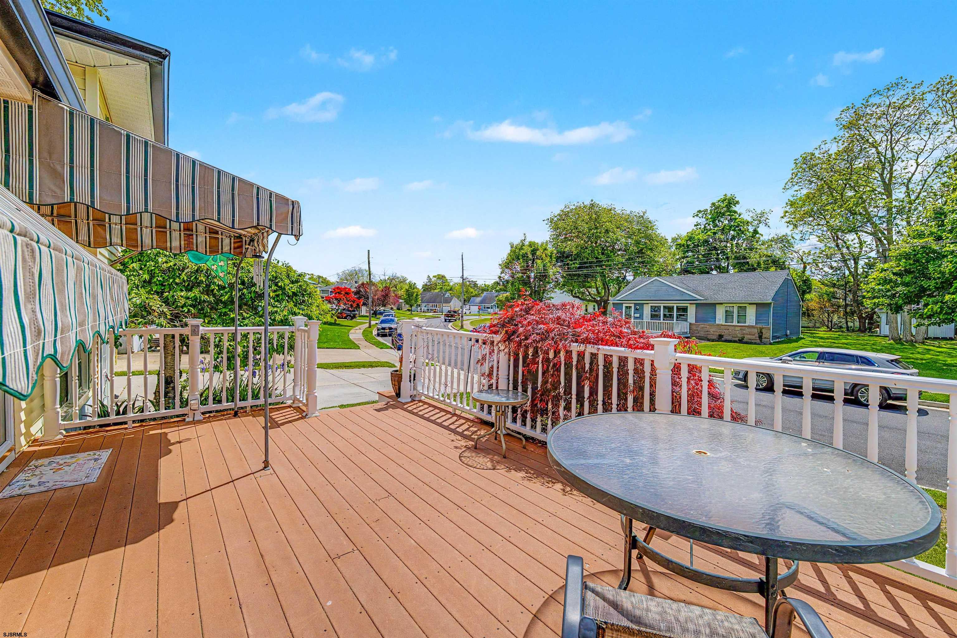 125 Exton Road Somers Point, NJ 08244 - Photo 6 of 35 a view of a roof deck with table and chairs a barbeque with wooden floor and fence