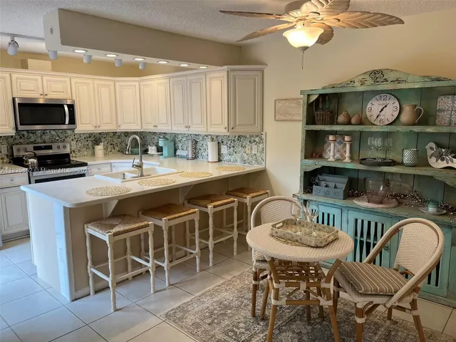 a kitchen with a dining table and chairs