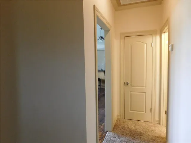 a view of room with window and a ceiling fan