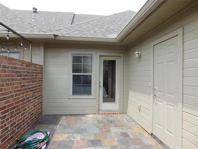 a view of a brick house with a small yard