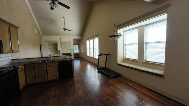 a kitchen with granite countertop stainless steel appliances and wooden cabinets