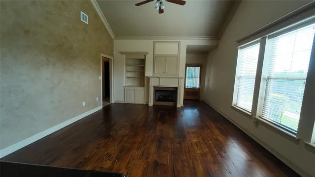 a kitchen with granite countertop a stove a sink and a window
