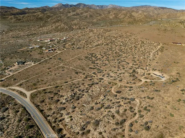 a view of a field with an ocean