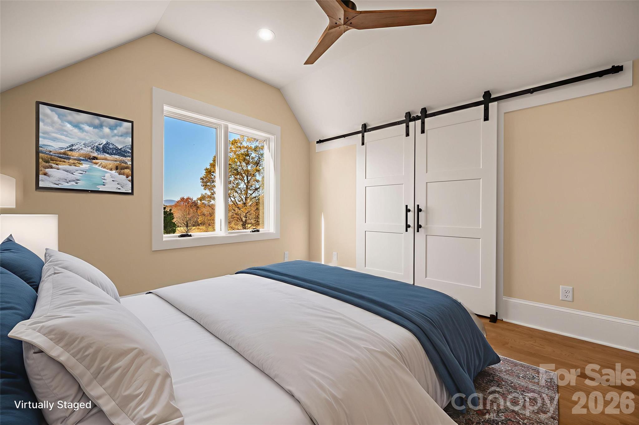 297 Mountain Meadows Lane, Unit 7 Tryon, NC 28782 - Photo 40 of 47 a bedroom with a bed and a painting on the wall