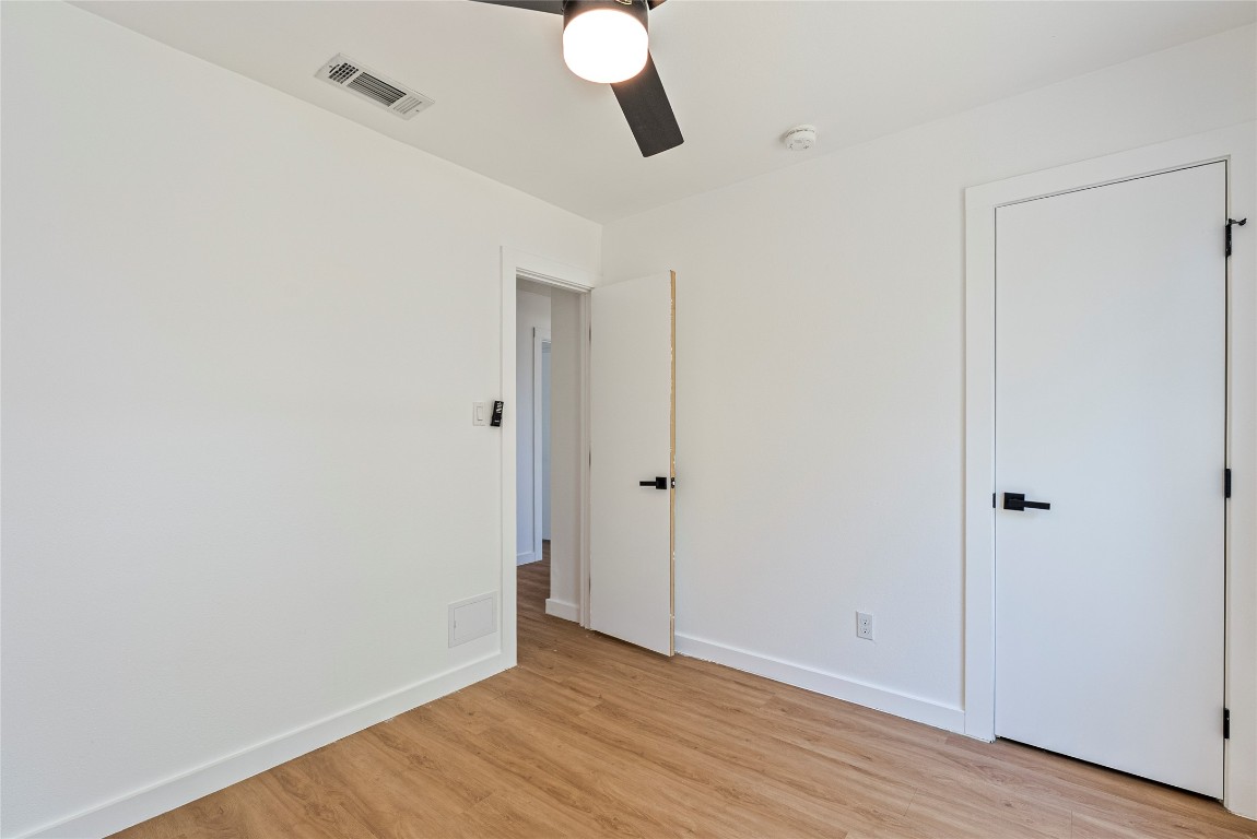 5200 King Charles Drive Austin, TX 78724 - Photo 18 of 22 Unfurnished bedroom featuring light wood-style floors and ceiling fan