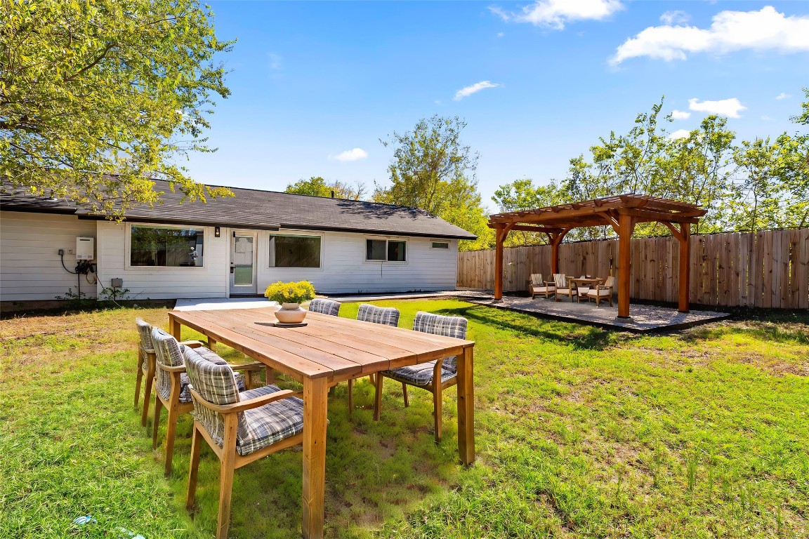 5200 King Charles Drive Austin, TX 78724 - Photo 21 of 22 Back of house with a patio, a pergola, and a fenced backyard