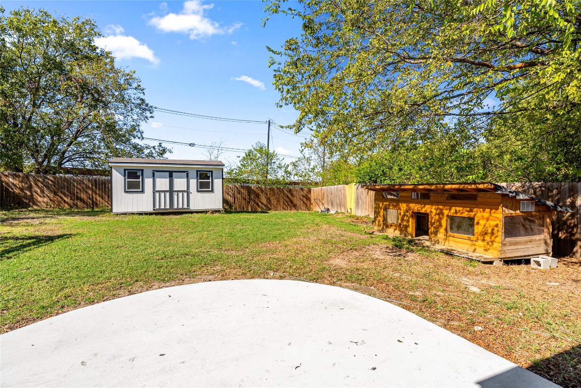 5200 King Charles Drive Austin, TX 78724 - Photo 22 of 22 Fenced backyard with a shed and a patio area