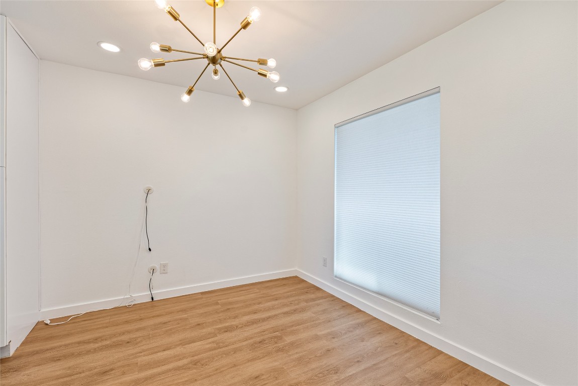 5200 King Charles Drive Austin, TX 78724 - Photo 7 of 22 Empty room featuring wood finished floors, a chandelier, and recessed lighting