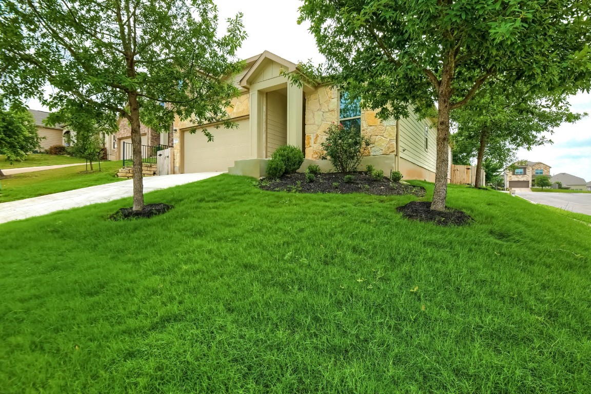 a front view of a house with garden