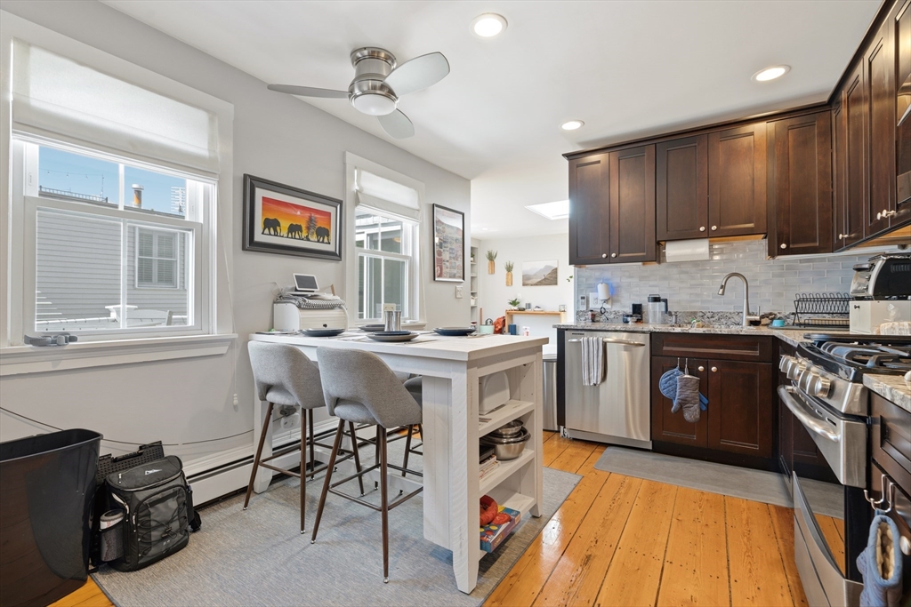 33 Mystic Street, Unit 3 Boston, MA 02129 - Photo 7 of 21 a kitchen with a sink a stove cabinets and a dining table