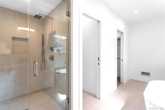 a bathroom with a shower sink and mirror