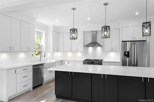 a kitchen with stainless steel appliances granite countertop a sink a stove a refrigerator and island