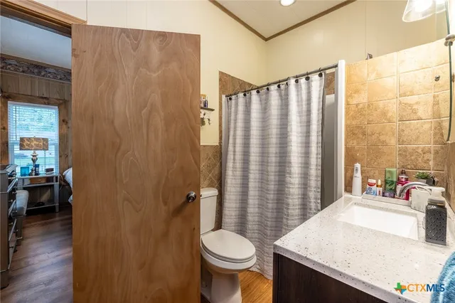 a bathroom with a sink toilet and shower