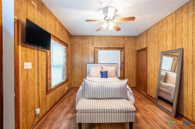 a bedroom with a bed and a window