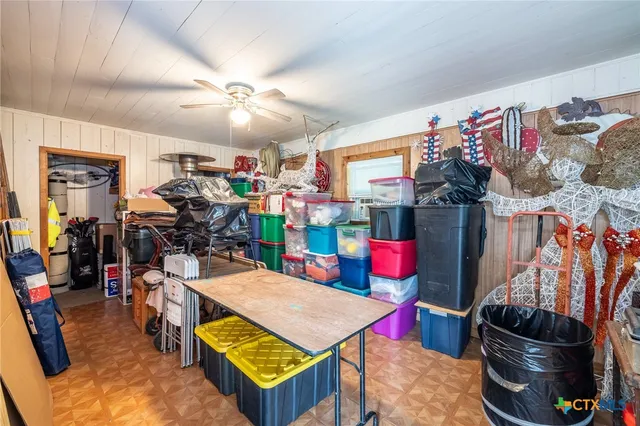 a front view of a house with a garden and tree