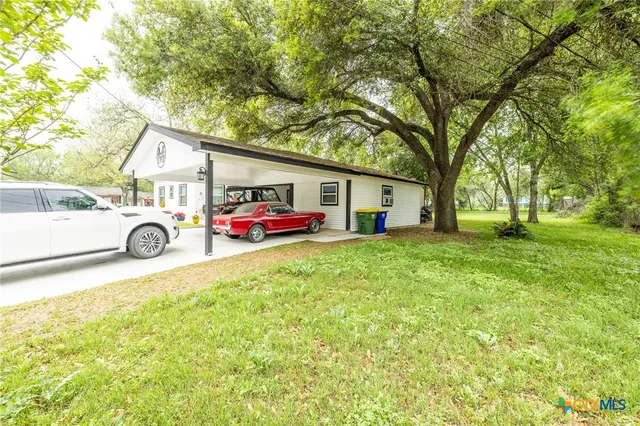 a view of a patio with a table and chairs