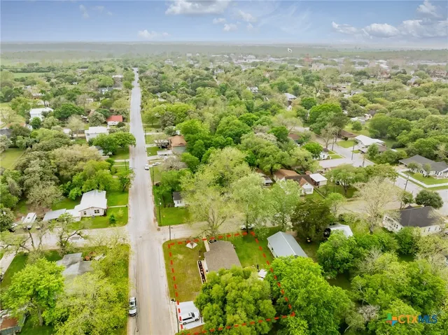 a front view of house with yard and swimming pool
