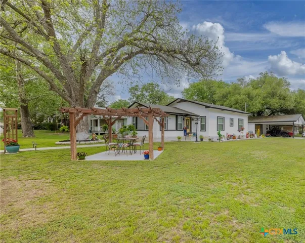 a view of a house with pool yard and sitting area