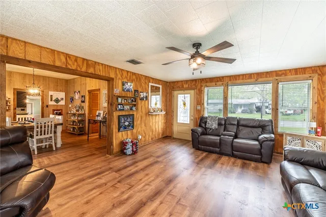 a living room with furniture and large windows