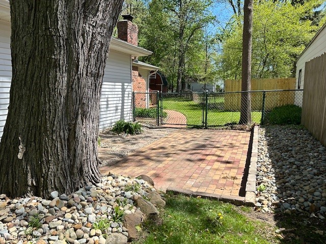 6589 Fairgrounds Road Painesville, OH 44077 - Photo 8 of 41 Brick patio with walkway leading to rear deck.