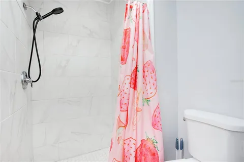 a bathroom with a shower curtain and a curtain