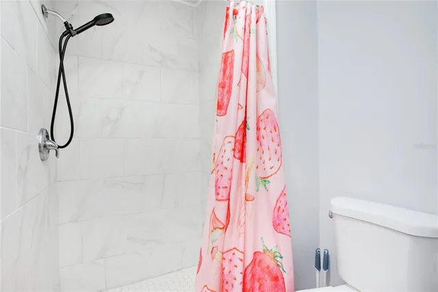 a bathroom with a shower curtain and a curtain