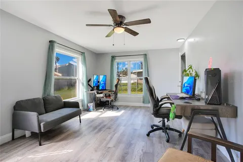 a living room with furniture a wooden floor and a window
