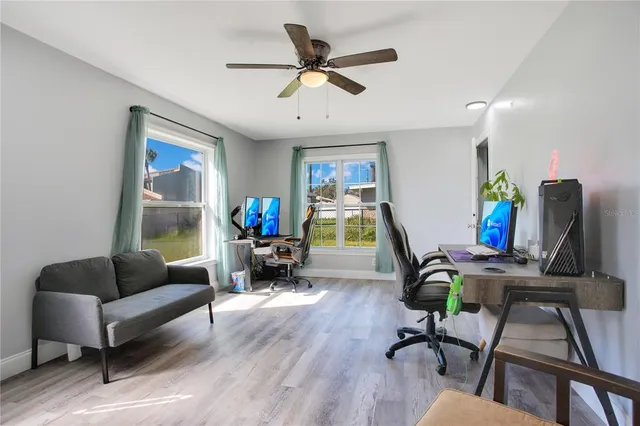 a living room with furniture a wooden floor and a window