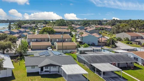 aerial view of a house with outdoor space and lake view