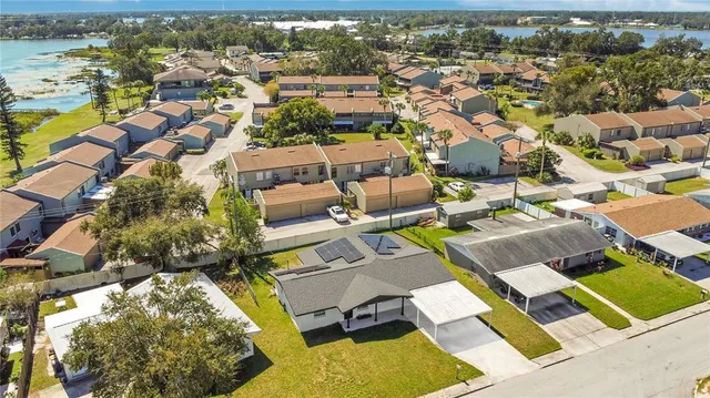 an aerial view of residential houses with outdoor space