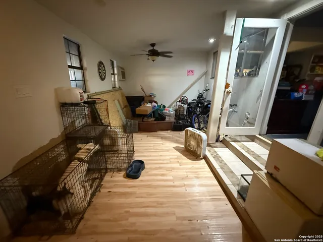 a view of a room with wooden floor and windows