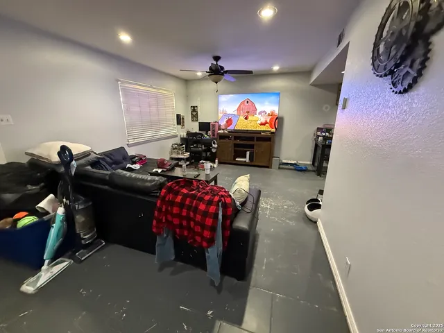 a room with furniture a flat screen tv and a chandelier