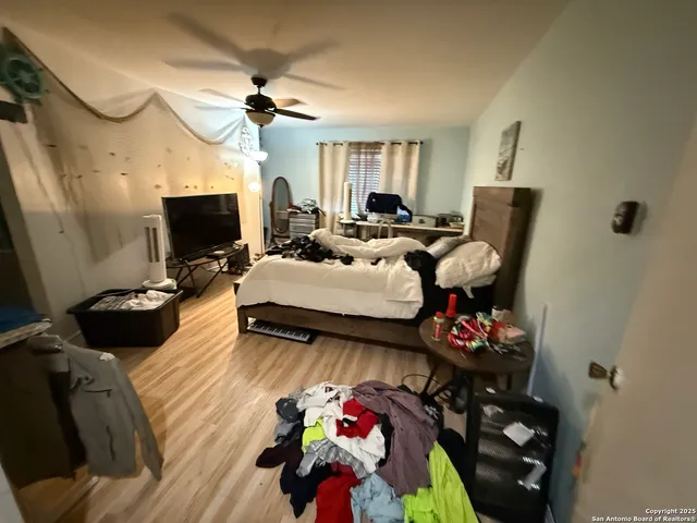 a bedroom with furniture and a flat screen tv