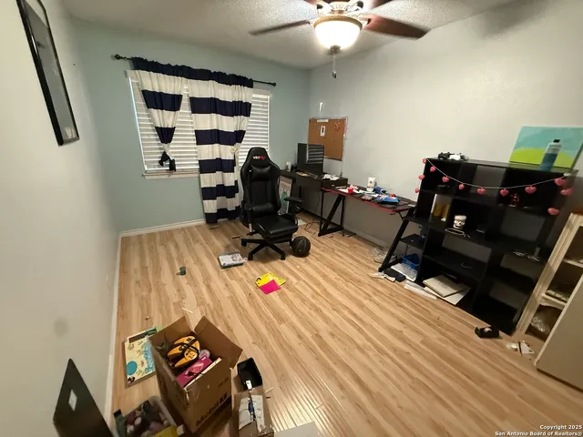 a view of a workspace with furniture and a window