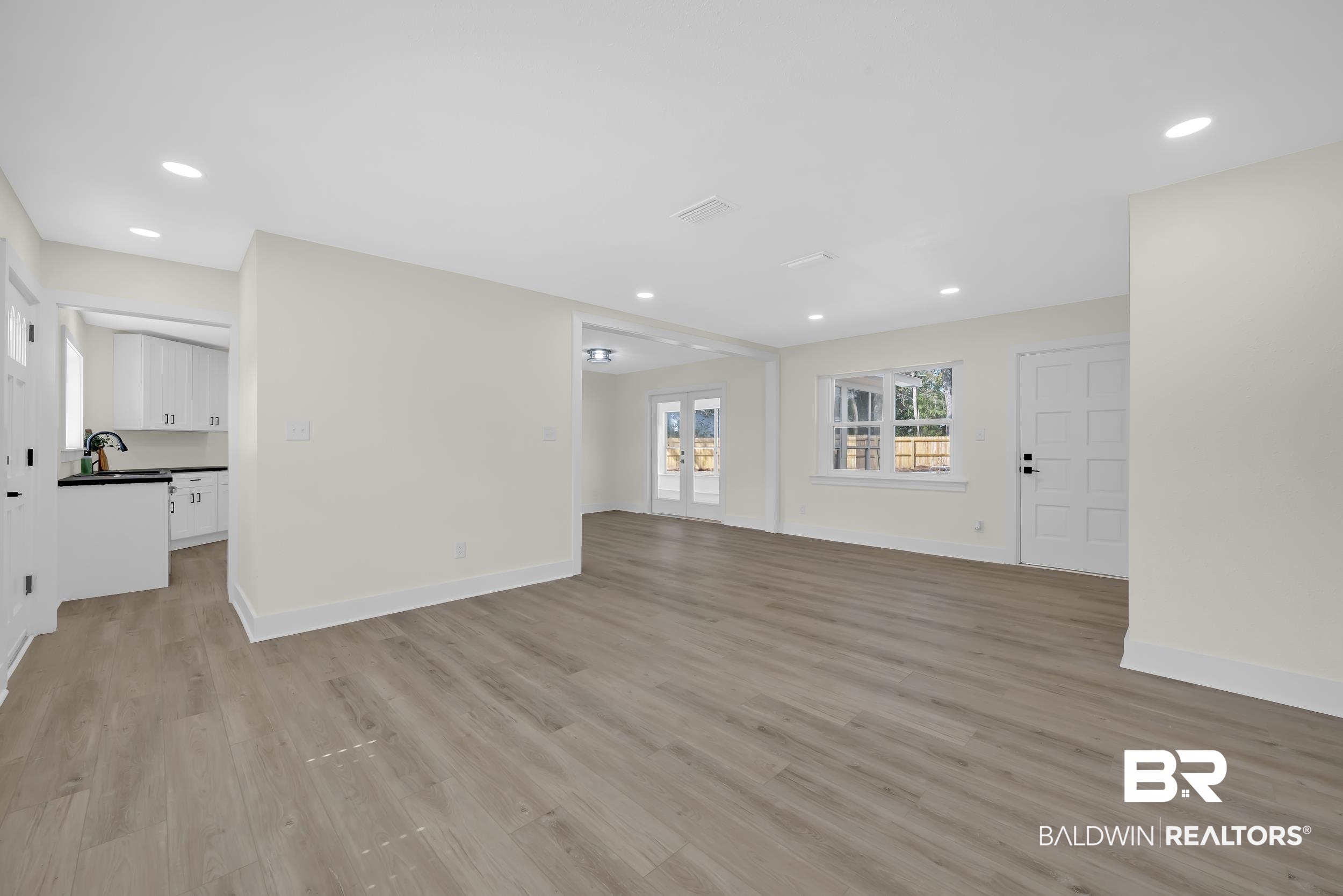 1409 Altair Lane Mobile, AL 36693 - Photo 5 of 23 Unfurnished living room with french doors, light wood-style floors, and recessed lighting
