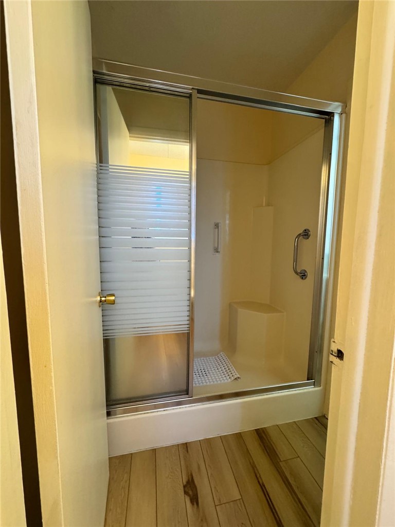 915 Maple Shade Road Alma, AR 72921 - Photo 11 of 18 Bathroom with a shower stall and light wood-type flooring