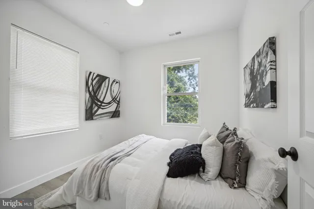 a bedroom with a bed and a window