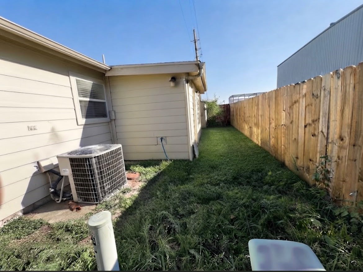19603 Rippling Brook Lane Tomball, TX 77375 - Photo 15 of 16 Well-maintained backyard with a grassy lawn.