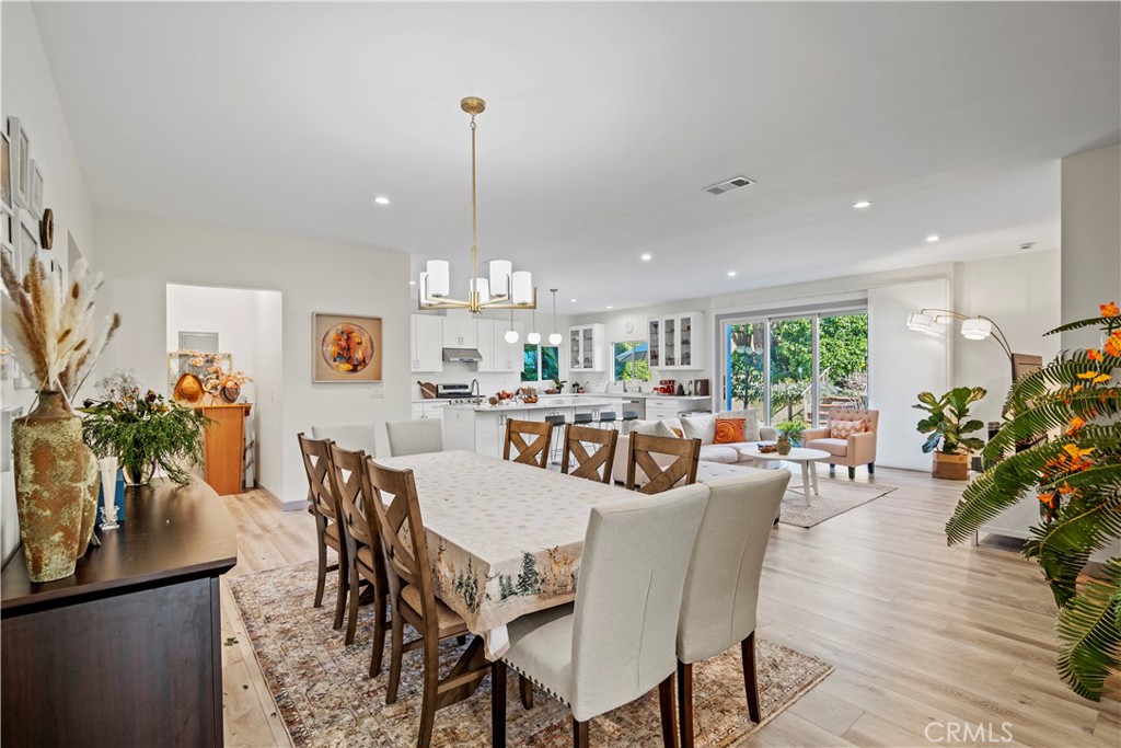 4704 Briggs Avenue La Crescenta, CA 91214 - Photo 13 of 28 a view of a dining room and livingroom with furniture a rug a potted plant and a chandelier