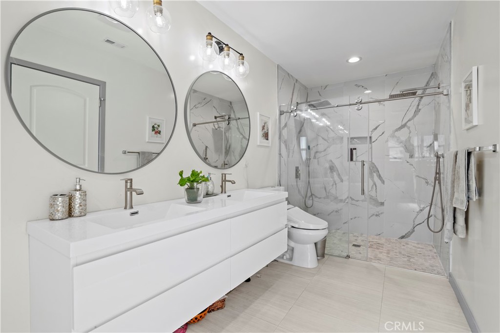 4704 Briggs Avenue La Crescenta, CA 91214 - Photo 17 of 28 a bathroom with a double vanity sink mirror and shower